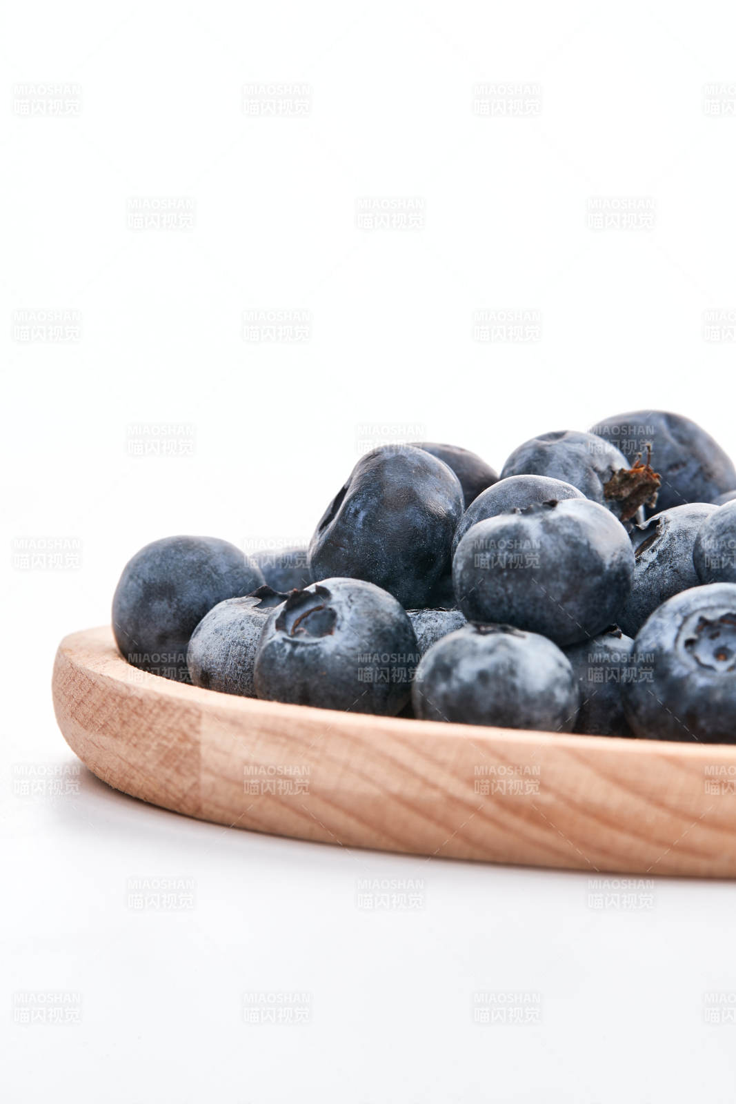 白色背景上摆放的水润新鲜蓝莓果图片