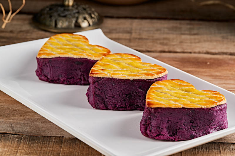 白色瓷盘装的茶餐烘焙酥皮心形紫薯泥图片