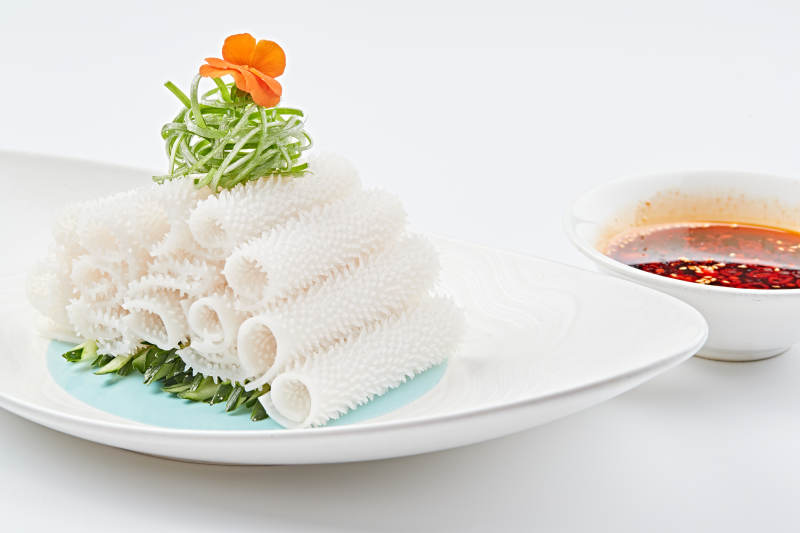 白色瓷盘装的红油墨鱼卷图片