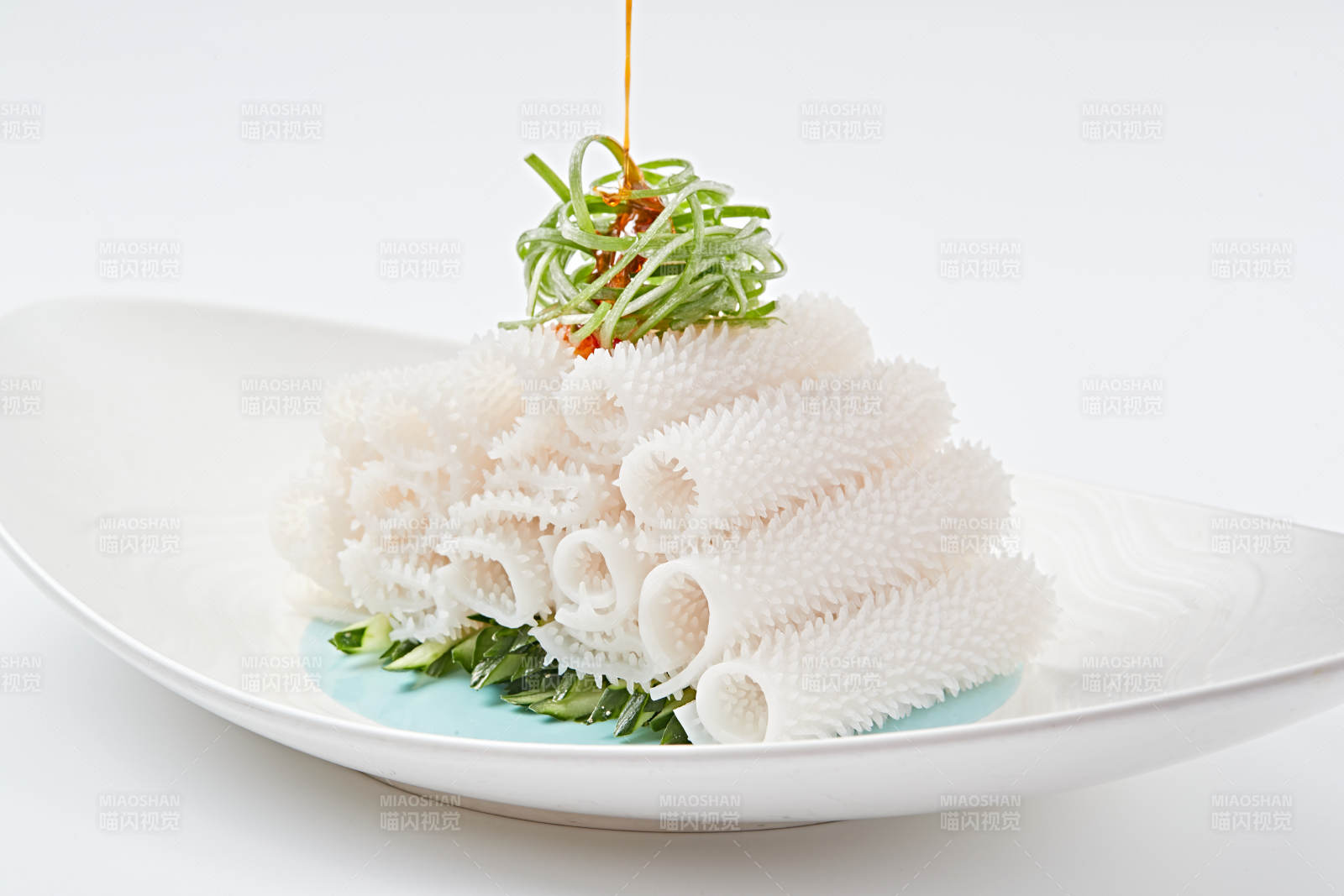 白色瓷盘装的红油墨鱼卷图片