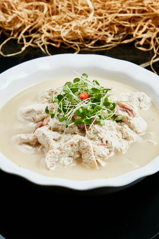 白色瓷餐具装的鲜鸡汤自制豆腐图片