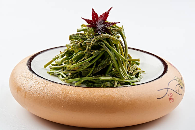 精美餐具装的焯水鲜香椿图片