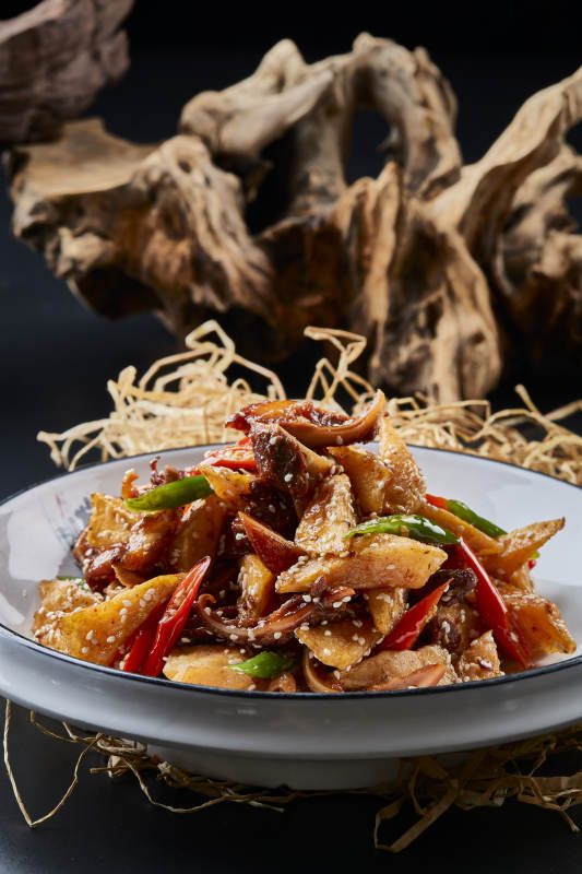 青瓷盘装的酱香红薯脆猪耳图片