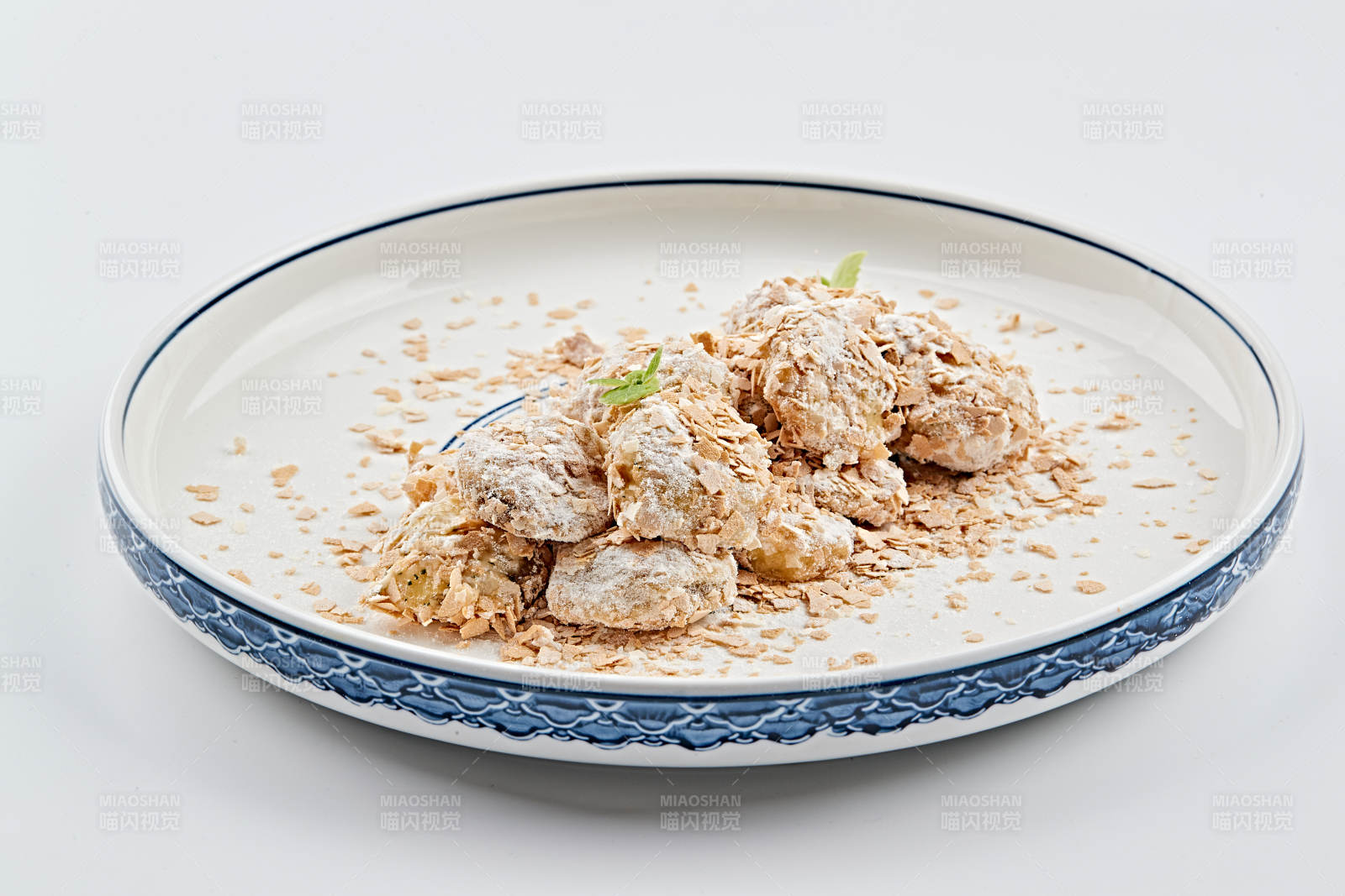 白色青花瓷盘装的香甜麦片炸茄盒图片