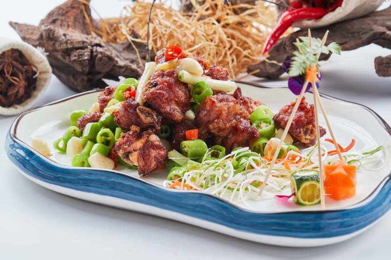 白色瓷盘装的的蒜香米椒烧鸡块图片