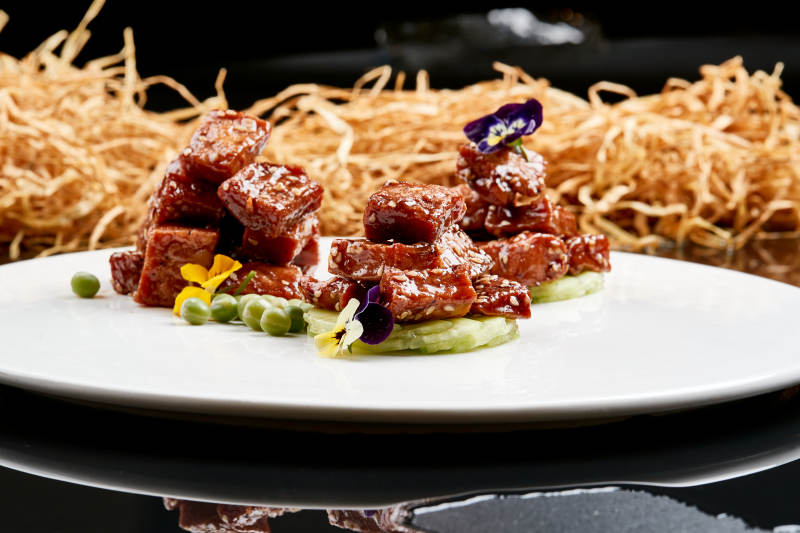 白色瓷盘装的酱腌杏鲍菇图片