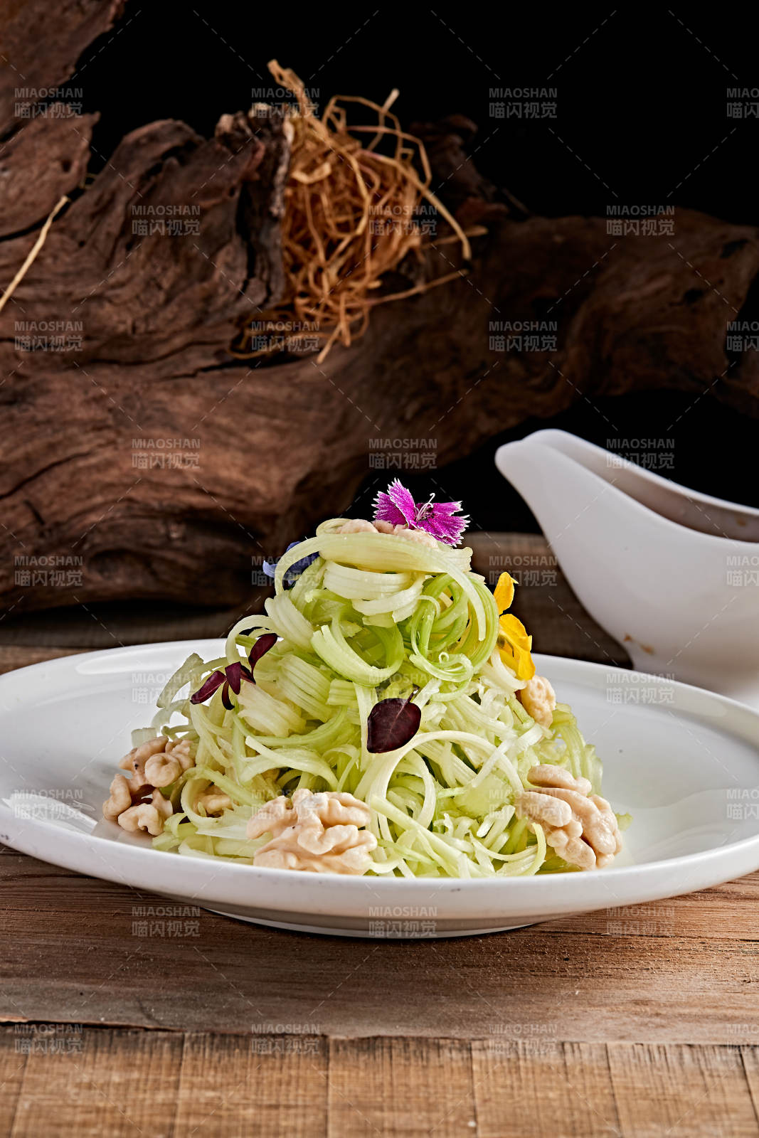 白色瓷盘装的浇汁桃仁西芹丝图片