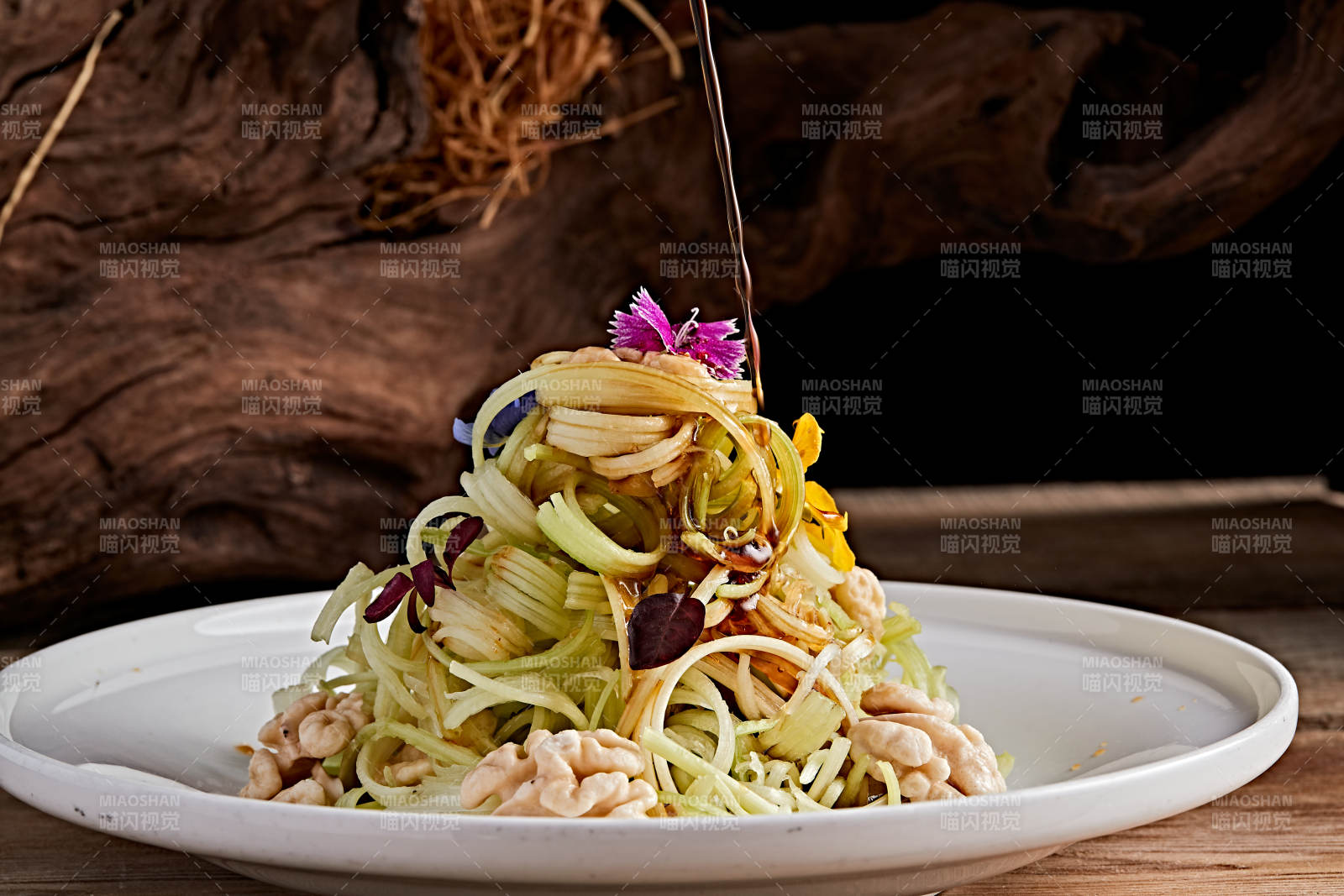 白色瓷盘装的浇汁桃仁西芹丝图片