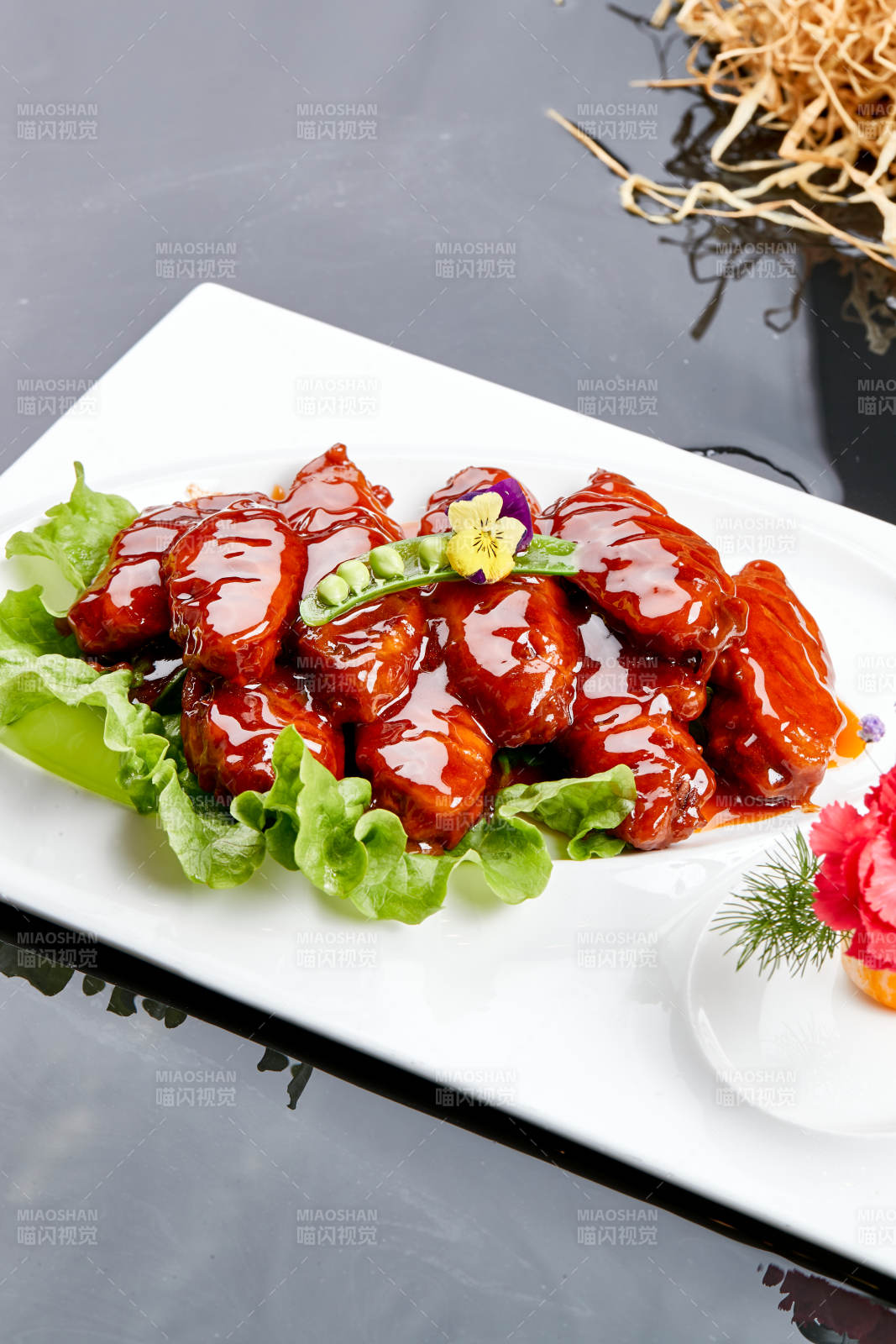 白色瓷盘装的蜜豆酱鸡翅中图片