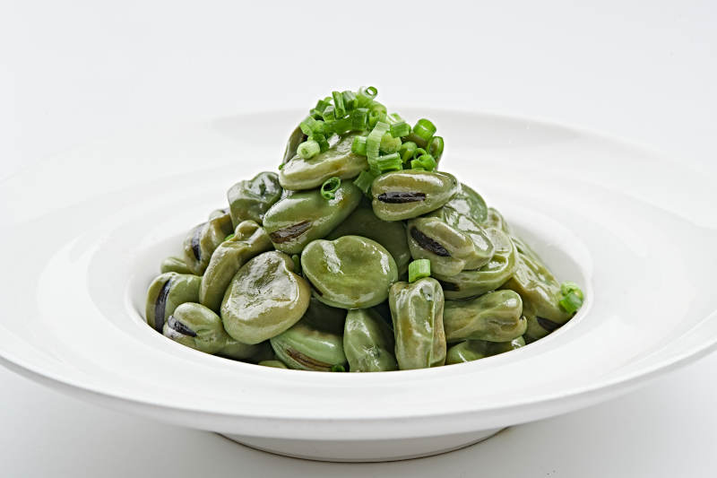 白色瓷盘装的腌渍蚕豆图片