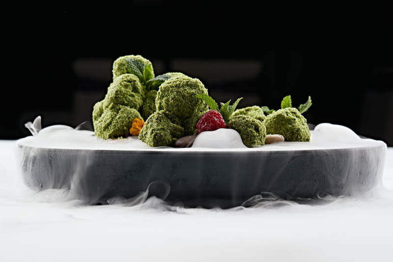 精美餐具装的干冰缭绕的抹茶和牛肉图片