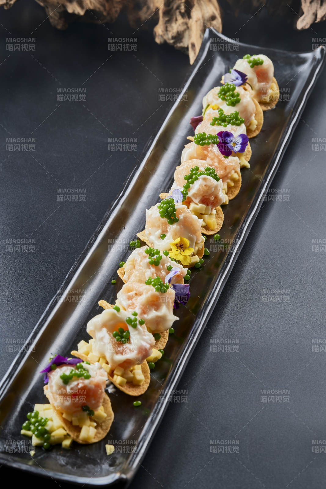 黑色长瓷盘装的青鱼子奶香芝士薯片焗虾仁图片