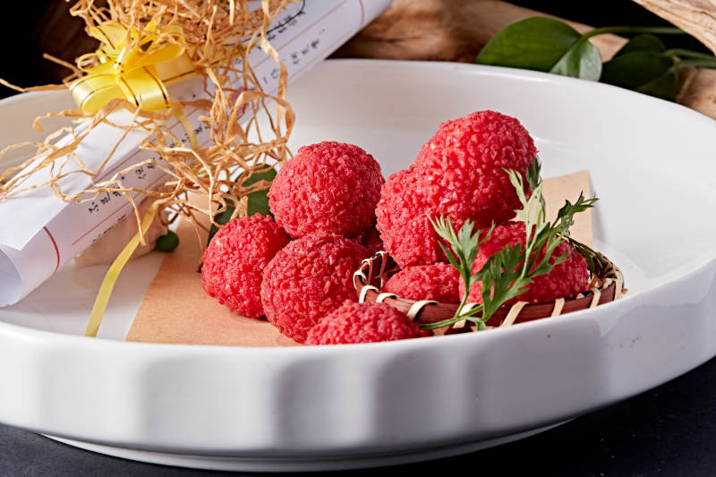 白瓷盘装的精美摆盘的荔枝大虾球图片