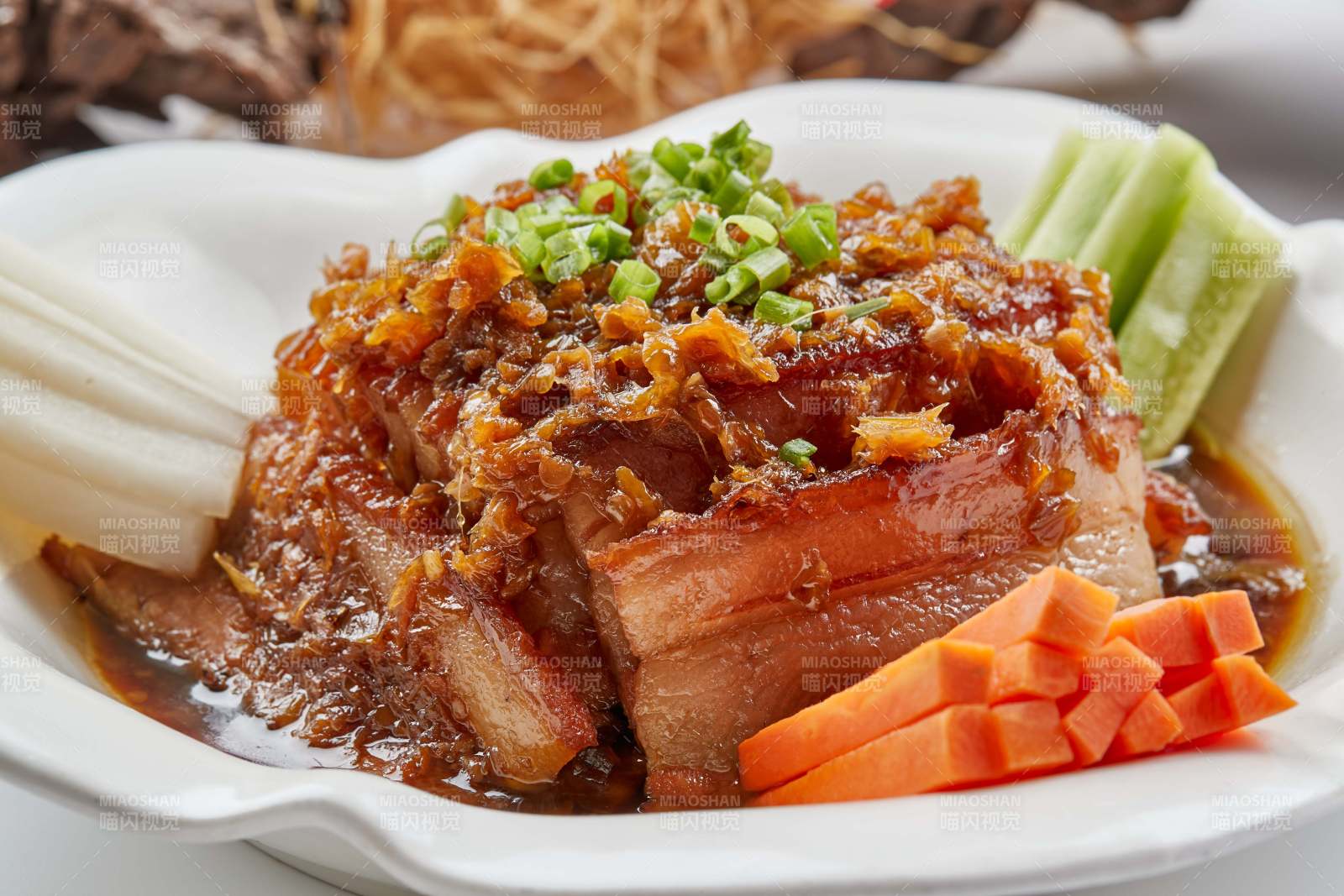 白色瓷餐具装的梅菜扣肉图片