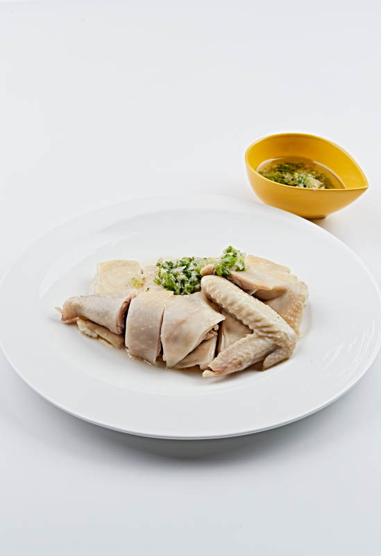 白色盘装的广式蘸汁白切鸡图片