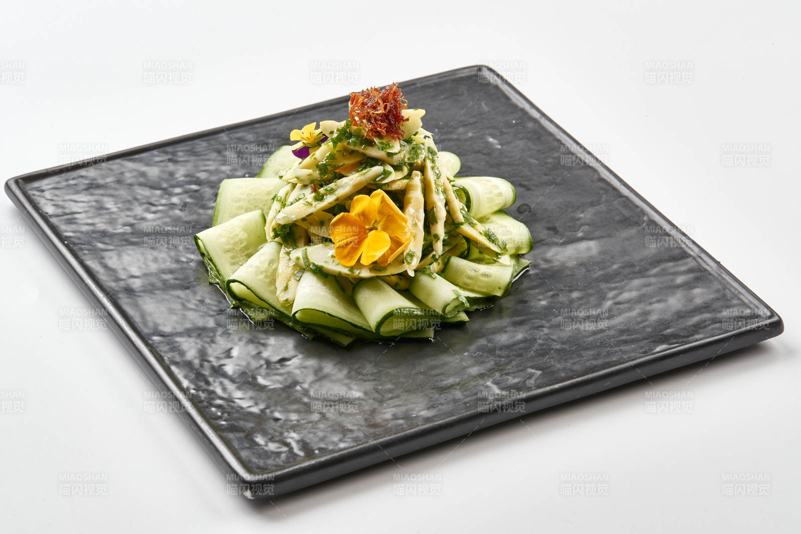 黑色石盘装的油渍春笋尖配乳瓜图片