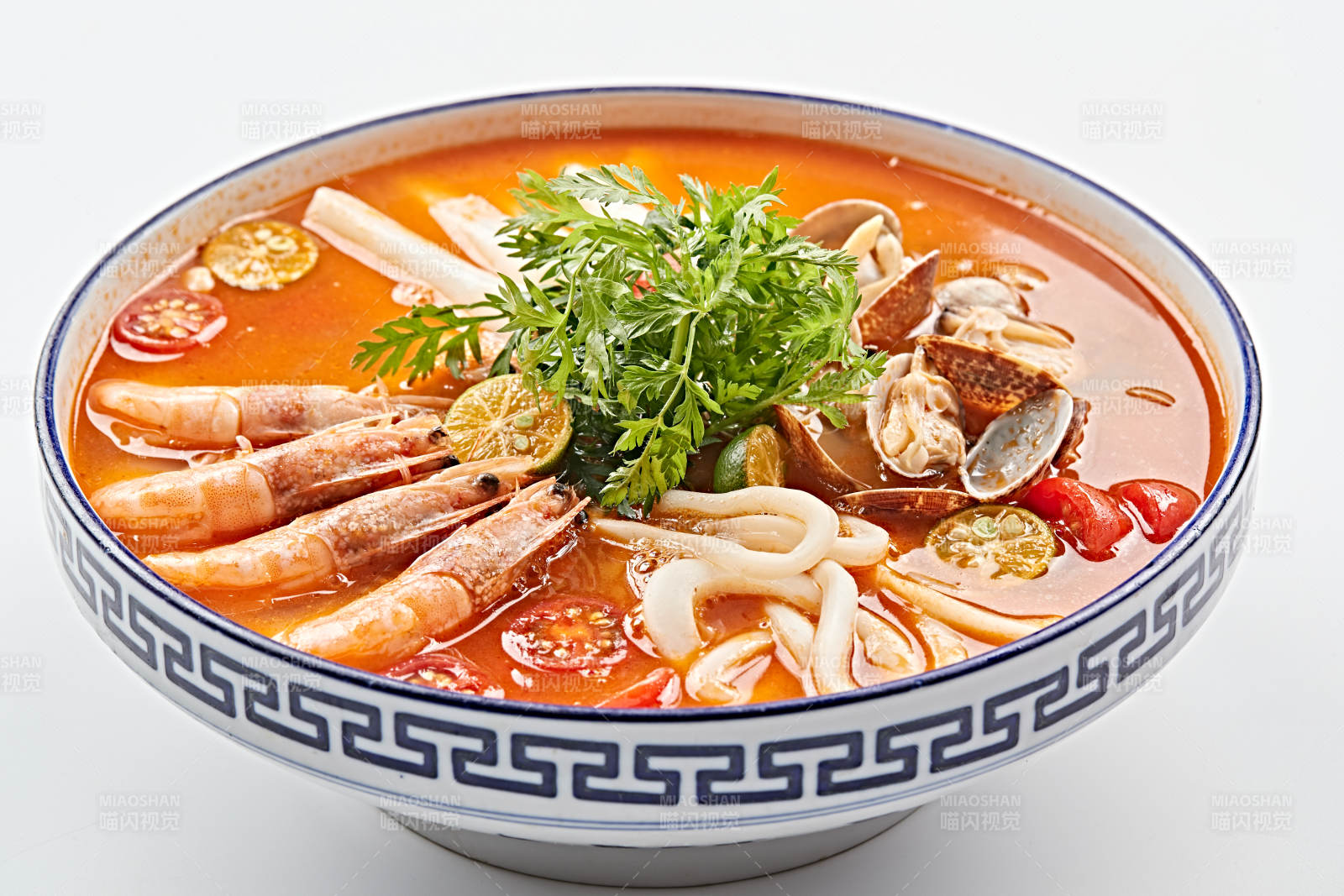 青花瓷碗装的泰式冬阴功酸辣海鲜年糕汤图片