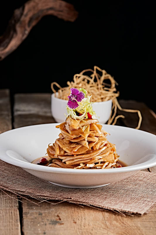 白色瓷盘装的醋腌萝卜皮图片