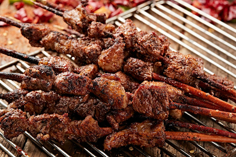 满是烟火气的烤炉上的鲜羊肉新疆红柳大串图片
