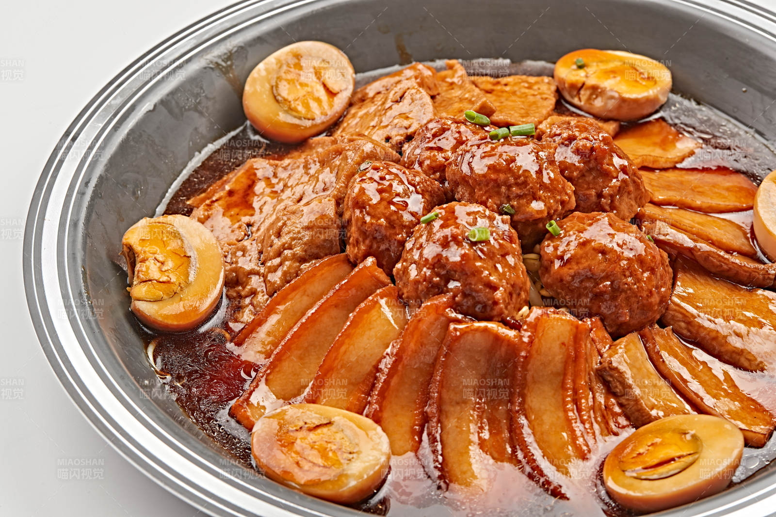 不锈钢餐具装的卤味鸡蛋豆腐丸子炖五花肉图片