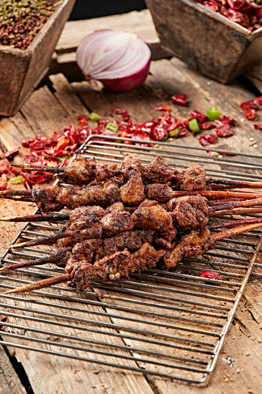 满是烟火气的烤炉上的鲜羊肉新疆红柳大串图片