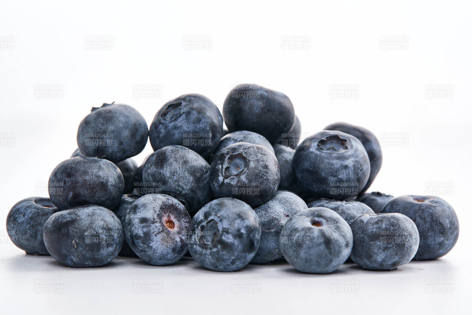 白色背景上摆放的水润新鲜蓝莓果图片