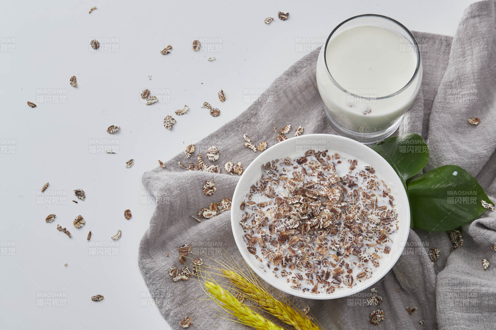 向装满低脂黑燕麦片的碗中倾倒牛奶图片