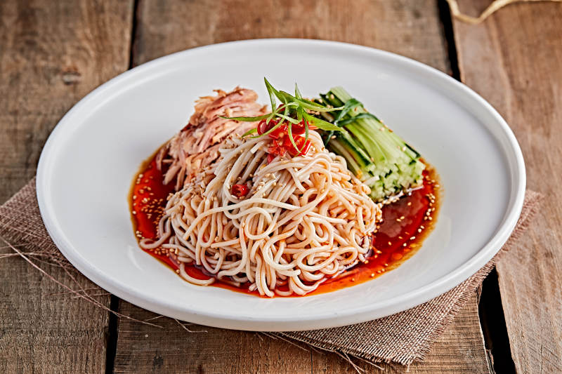 白色瓷盘装红油鸡丝冷面图片