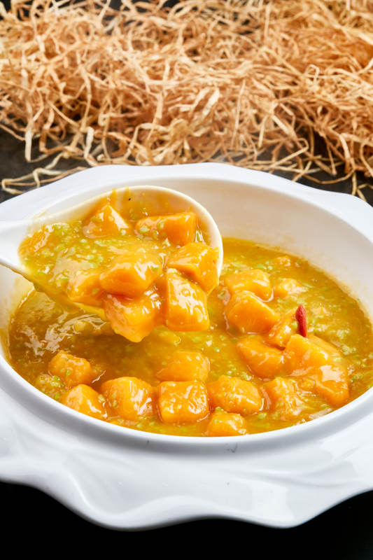 白色瓷餐具装的浓香青豆金米南瓜羹图片