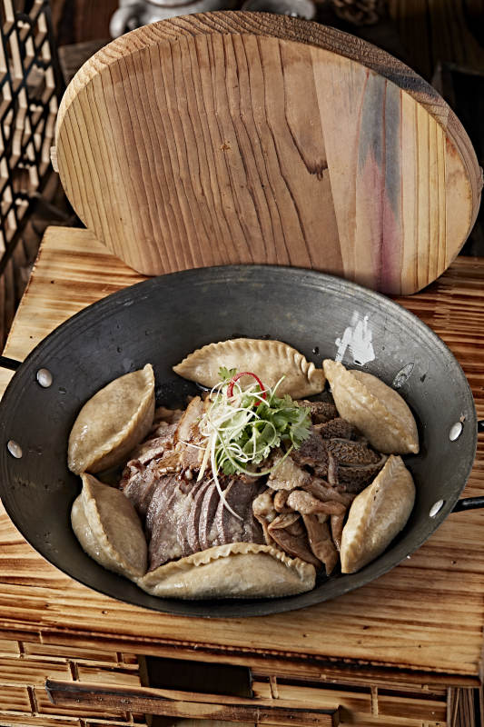 农家灶台铁锅炖猪杂配莜面蒸饺图片