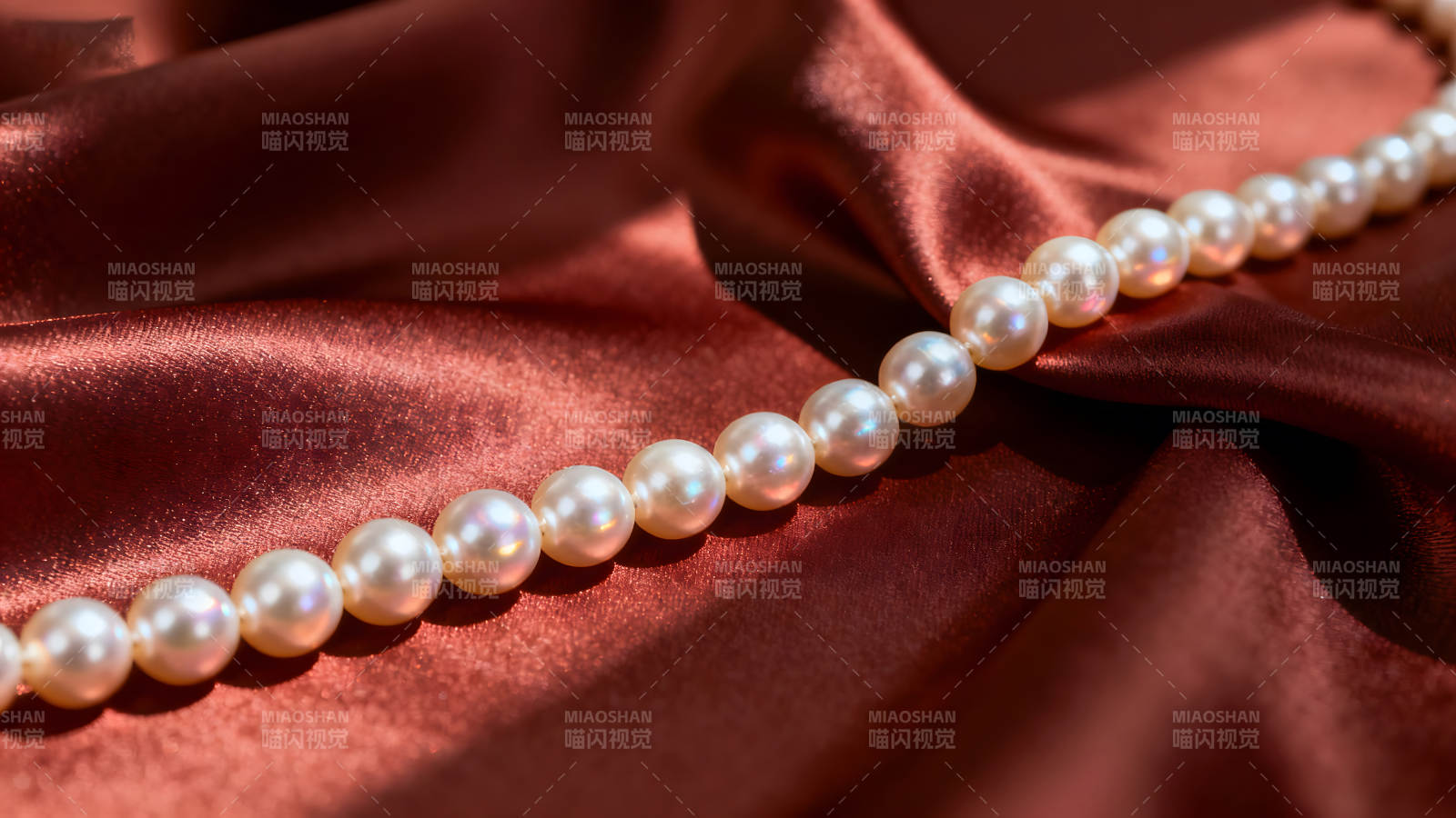 珍珠项链在红绸缎上闪耀图片