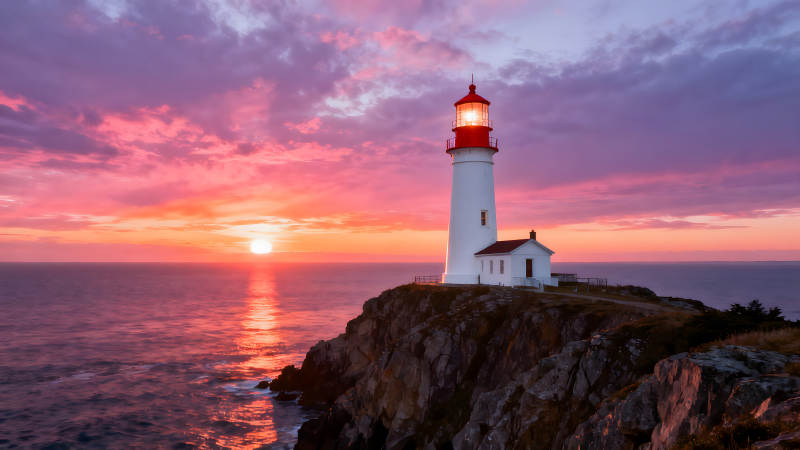 灯塔夕阳下的海岸风光图片