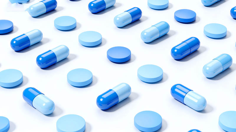 蓝色药丸胶囊排列设计图片