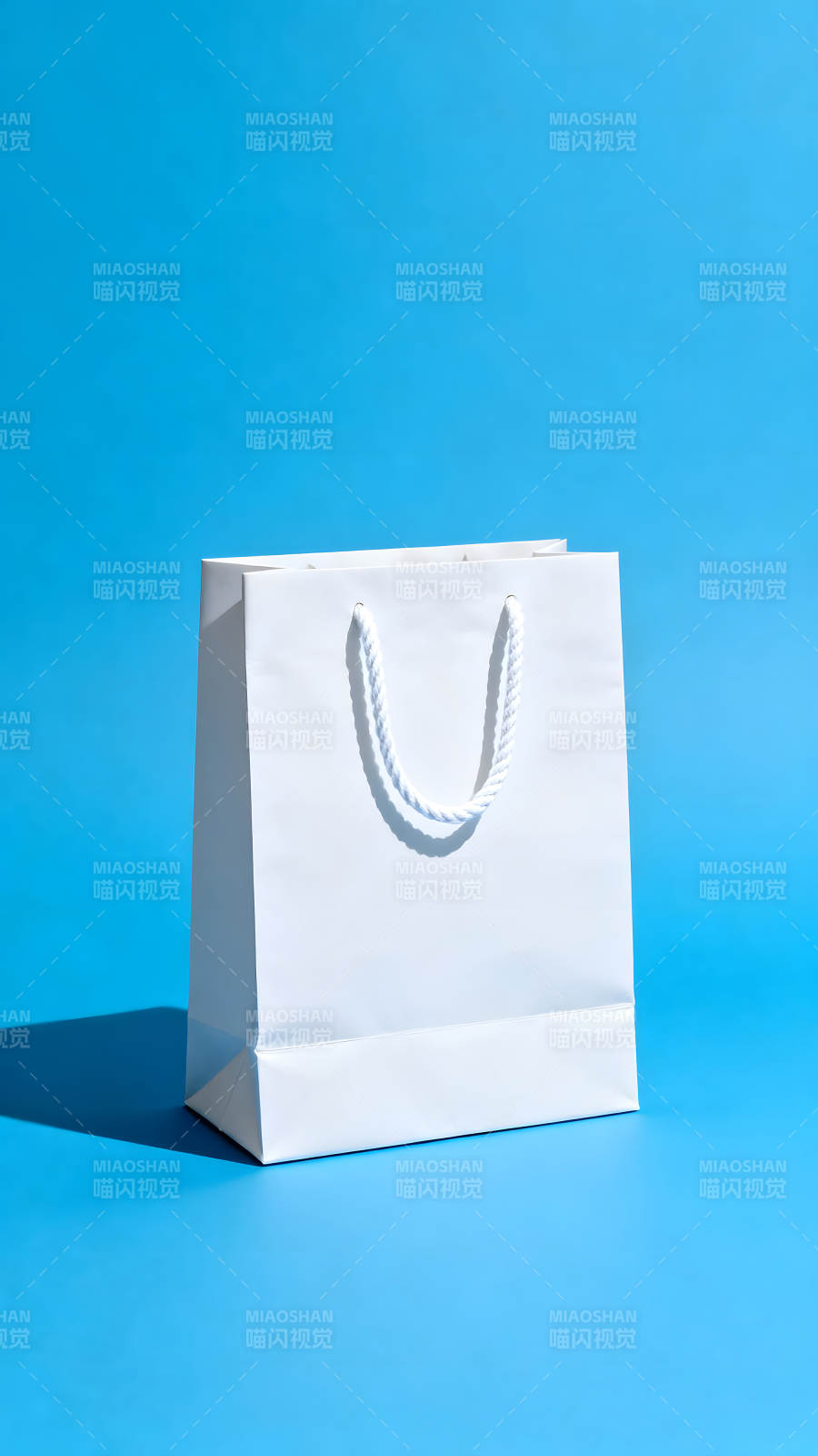 白色购物袋在蓝色背景上图片
