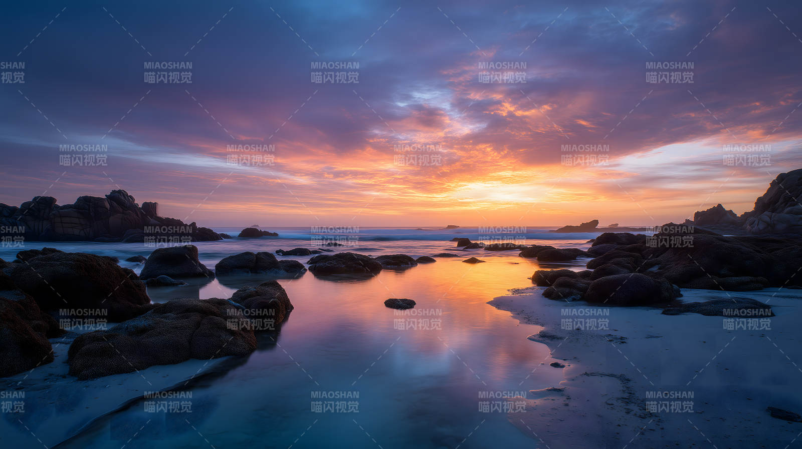 落日余晖下的岩石海岸图片