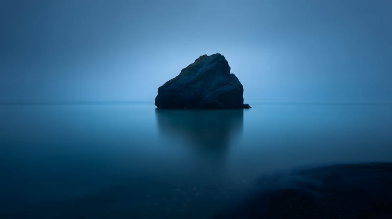 平静海面上的孤石图片