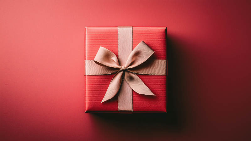 深红色礼盒上的金色丝带图片