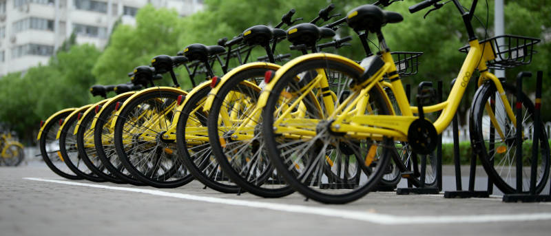 整齐排列的黄色共享单车图片
