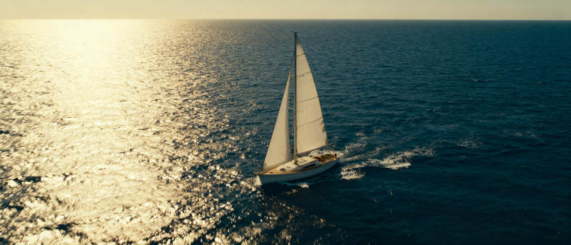 帆船远航日落海面图片