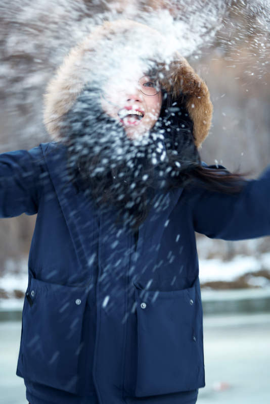在野外雪地欣赏雪景游玩拍照的亚洲女性图片