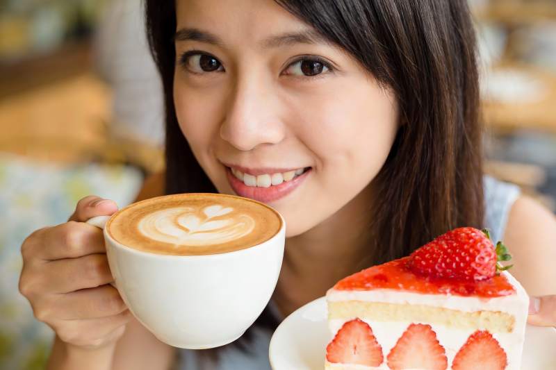 女子咖啡甜品微笑特写图片