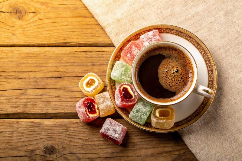 咖啡与糖果的木质桌面静物图片