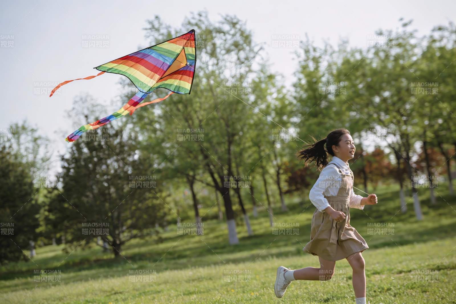 女孩草地上放风筝图片