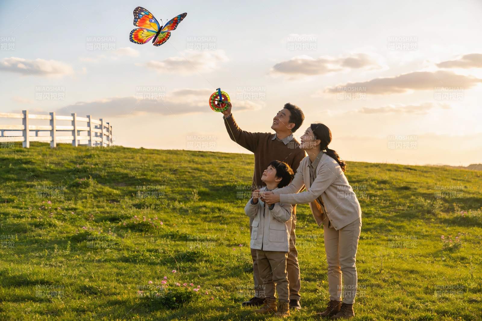 一家三口草地上放风筝图片