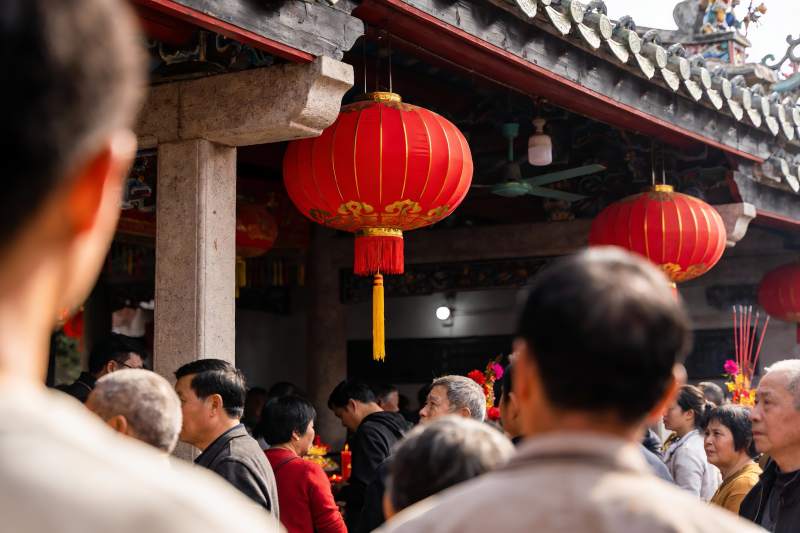 古建筑前人群聚集挂红灯笼图片