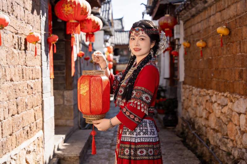 身着民族服饰女子手持红灯笼图片
