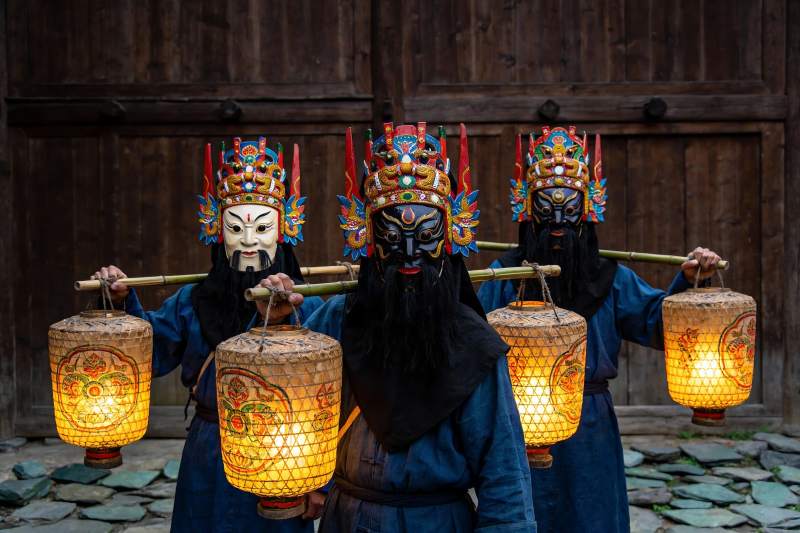 三人戴面具持灯笼表演传统节目图片