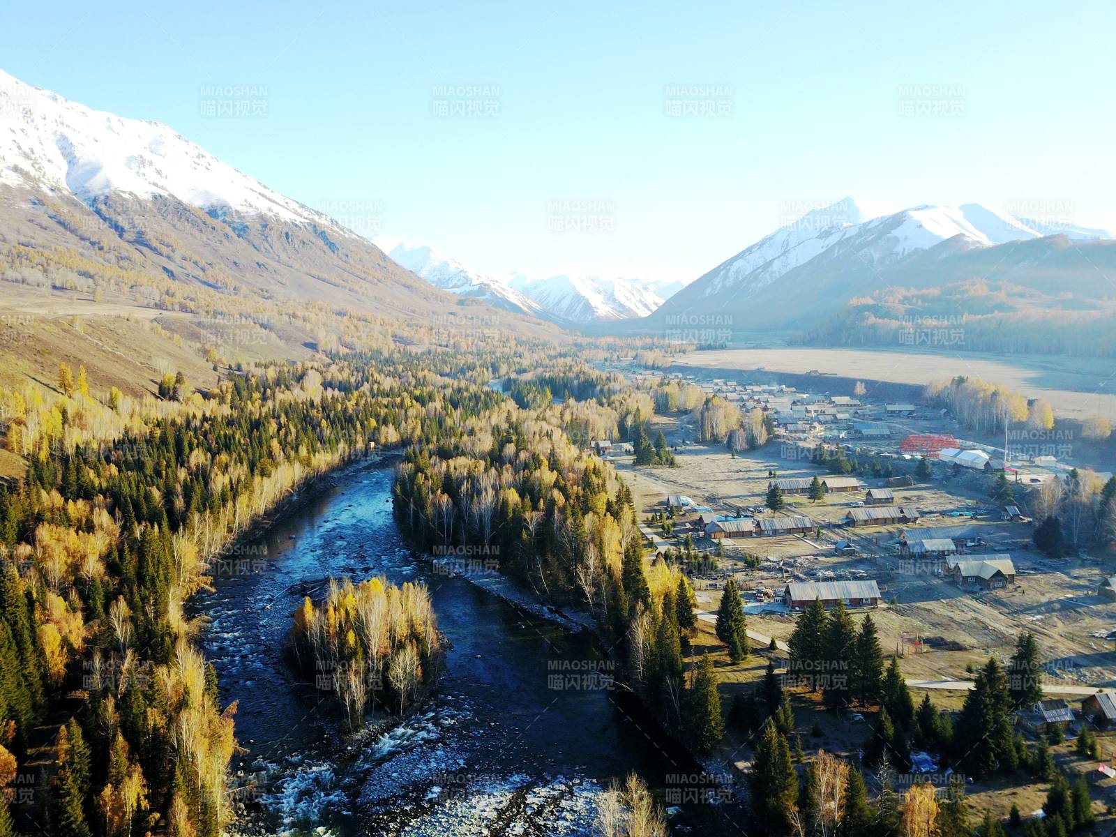 禾雪山环绕的秋日山谷图片