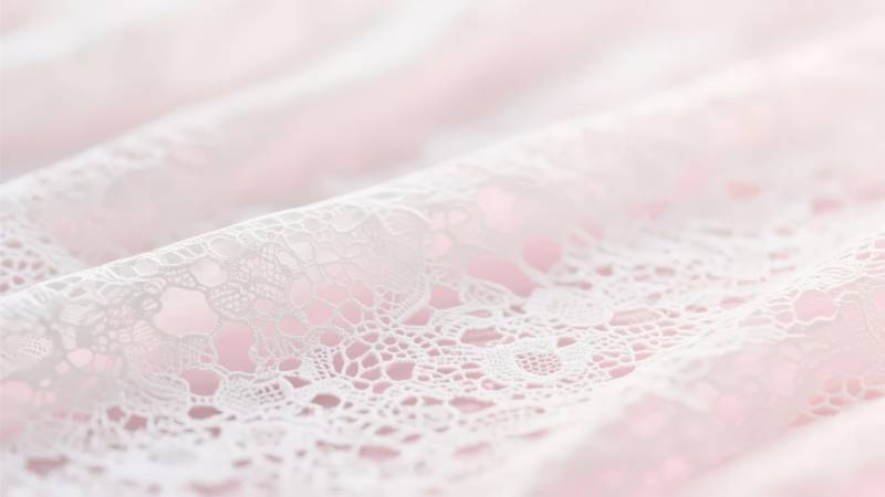 粉色蕾丝布料特写图片