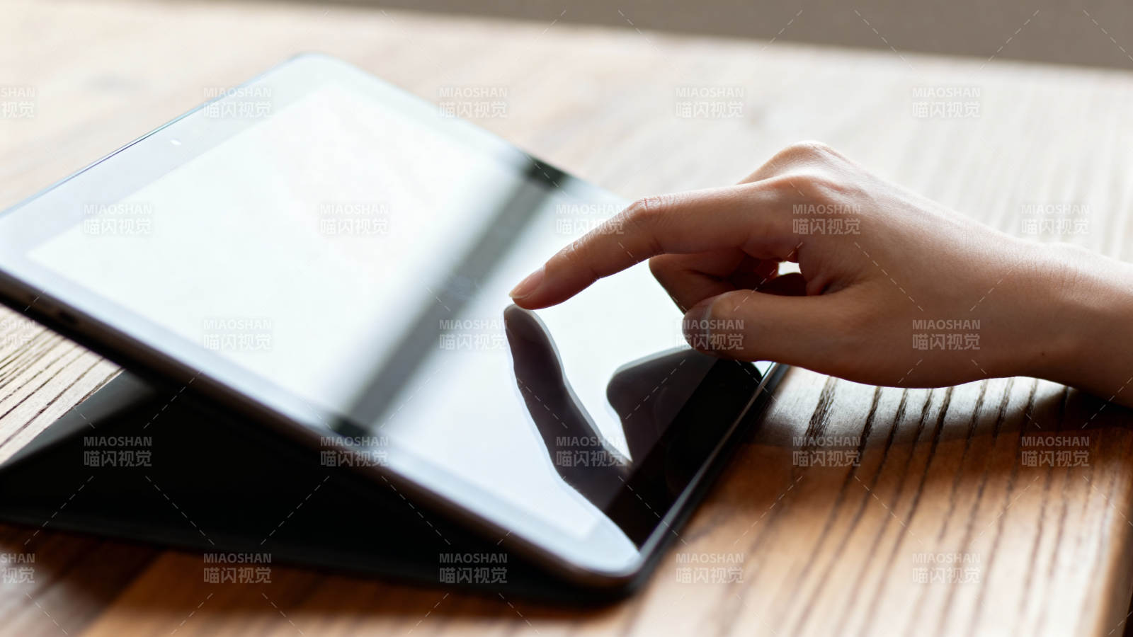 手指轻触平板屏幕图片